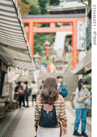 Woman tourist Visiting in Enoshima Island, Fujisawa, Kanagawa, Japan. happy Traveler sightseeing Enoshima Shrine. Landmark and popular for tourists attraction near Tokyo. Travel and Vacation concept Woman tourist Visiting in Enoshima Island, Fujisawa, Kanagawa, Japan. happy Traveler sightseeing Enoshima Shrine. Landmark and popular for tourists attraction near Tokyo. Travel and Vacation concept 110364513