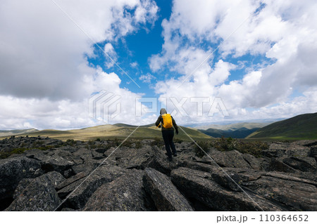 Hiking woman on high altitude mountain top 110364652