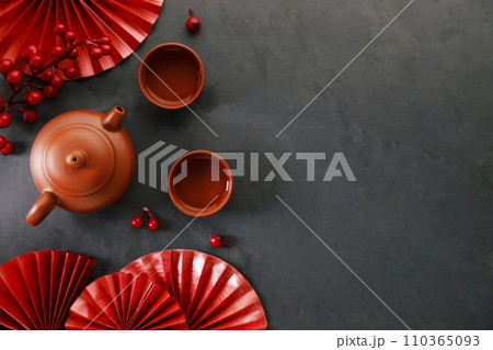 Chinese new year festival decorations with classic clay teapot and red Chinese folded fans. 110365093