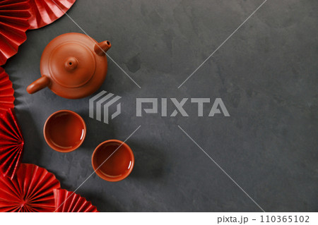 Chinese new year festival decorations with classic clay teapot and red Chinese folded fans. 110365102