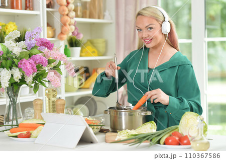 beautiful emotional young woman cooking in kitchen beautiful emotional young woman cooking in kitchen 110367586