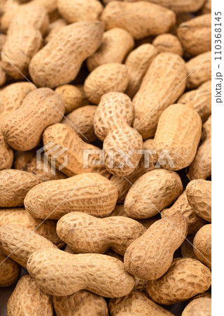 Unshelled peanuts as a background, top view. Food peanut closeup Unshelled peanuts as a background, top view. Food peanut closeup 110368145