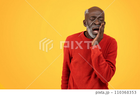 Senior Black man with a white beard touching his cheek in pain, possibly having a toothache Senior Black man with a white beard touching his cheek in pain, possibly having a toothache 110368353