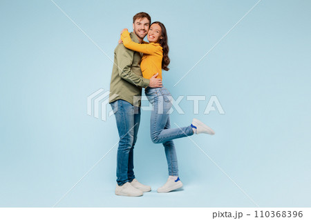Joyful couple embracing, woman lifted in romantic hug 110368396