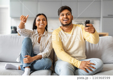 Portrait Of Happy Indian Spouses Watching Tv At Home Together Portrait Of Happy Indian Spouses Watching Tv At Home Together 110368599
