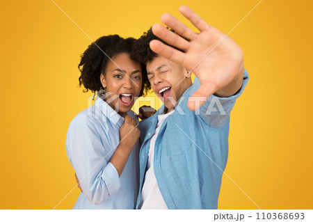 Sad excited young african american guy and woman in casual with open mouth Sad excited young african american guy and woman in casual with open mouth 110368693