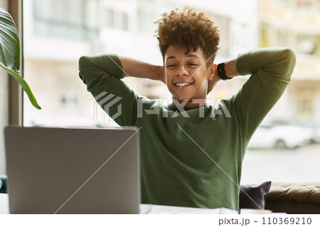 Happy young black guy businessman looking at laptop screen 110369210
