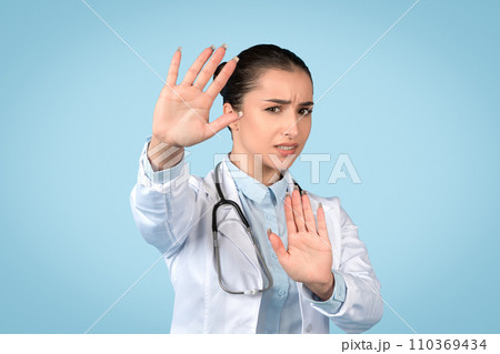 Woman doctor gesturing stop, health precaution sign 110369434