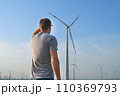 The man stands with his back and looks at the wind 110369793