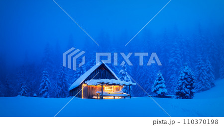A serene winter scene with a lonesome wooden house 110370198