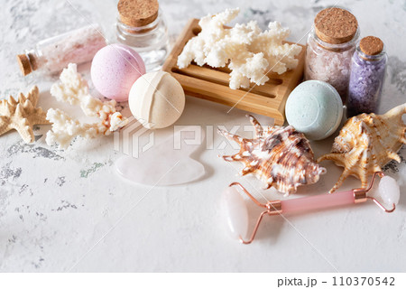 Spa beauty products for body and face home skin care on white background. white towel, bar of soap, jar of cream, pink face roller, wooden brush, and starfish. Self-Care and Beauty concept Spa beauty products for body and face home skin care on white background. white towel, bar of soap, jar of cream, pink face roller, wooden brush, and starfish. Self-Care and Beauty concept 110370542