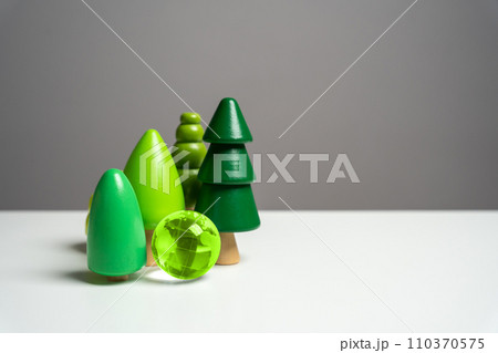 Green globe planet earth surrounded by forest trees. Environmental protection. Conservation of forests and nature reserves. Innovative technologies to reduce the impact on the environment. 110370575