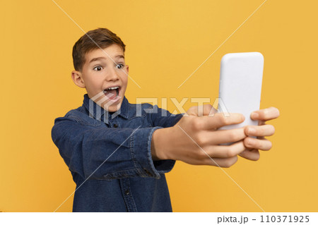 Cheerful Excited Teen Boy Looking At Smartphone Screen With Shock 110371925
