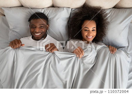 Top View African Couple Lying In Bed Covered With Blanket Top View African Couple Lying In Bed Covered With Blanket 110372004