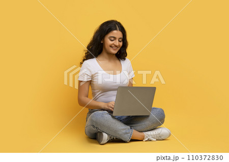Smiling young indian woman enjoying newest educational course Smiling young indian woman enjoying newest educational course 110372830