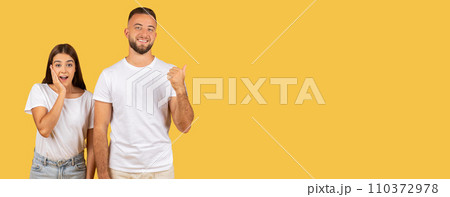 Two cheerful young adults wearing plain white t-shirts and jeans stand Two cheerful young adults wearing plain white t-shirts and jeans stand 110372978