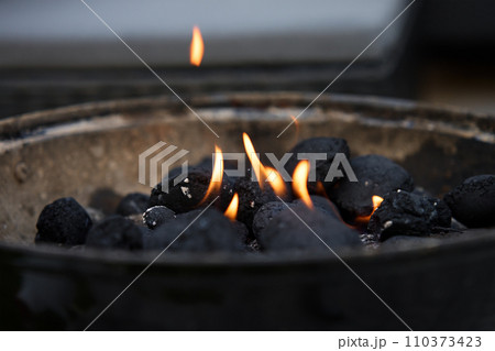 Smoldering coals in the grill. Burning coals for barbecue during a picnic 110373423