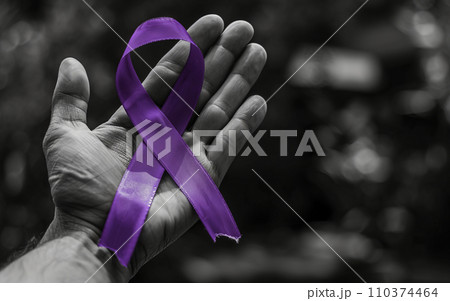 Palm with fingers extended, holding a purple ribbon symbolizing overdose awareness. Overdose Awareness Day 110374464