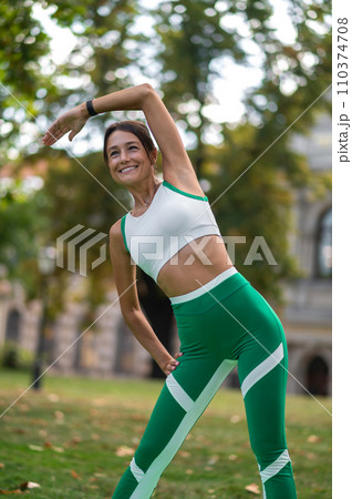 Young woman exercising and stretching to the sides Young woman exercising and stretching to the sides 110374708