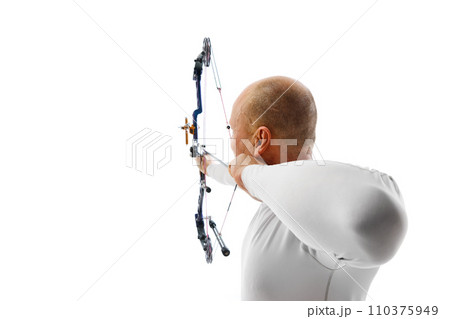 Back view image of man, archery at hele aiming with archery bow on target isolated over white studio background. Archery sport, competition Back view image of man, archery at hele aiming with archery bow on target isolated over white studio background. Archery sport, competition 110375949