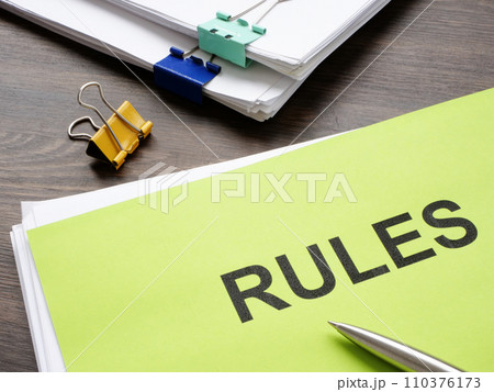 A stack of documents with rules in the office. A stack of documents with rules in the office. 110376173