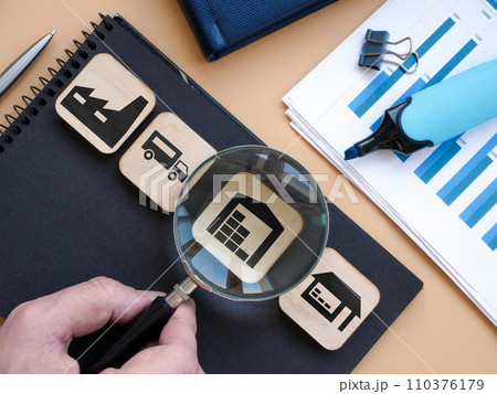 Product supply chain and warehouse. Hand holds a magnifying glass. Product supply chain and warehouse. Hand holds a magnifying glass. 110376179