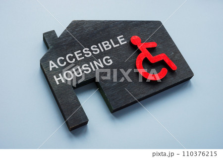 Accessible housing. Model of house and disabled person sign. 110376215