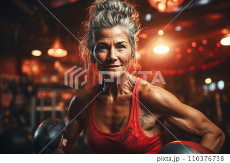 Portrait of athletic gray hair woman working out in gym . Fitness and bodybuilding concept 110376738