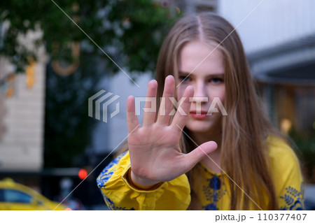 Teenage girl showing stop sign with hand. Soft selective focus. Stop teen bullying concept Teenage girl showing stop sign with hand. Soft selective focus. Stop teen bullying concept 110377407