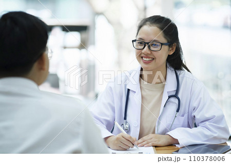 Doctor talking to a patient at medical clinic.. Doctor talking to a patient at medical clinic.. 110378006