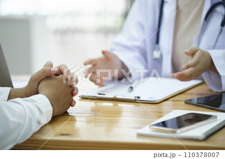 Doctor and patient. Doctor having a checkup with a patient at clinic. Doctor and patient. Doctor having a checkup with a patient at clinic. 110378007