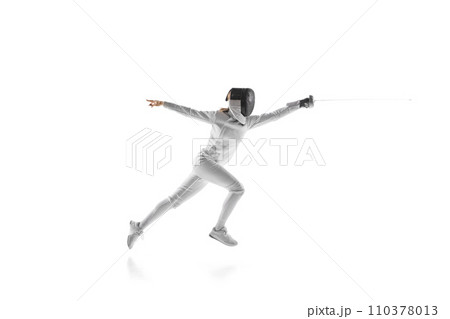 Dynamic portrait of fierce sportswoman while lightning-fast fencing battle against white studio background. Intensity and skill of this elegant combat sport. 110378013