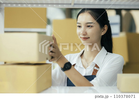 Happy entrepreneurs using tablets for check order and Checking stock for delivering products to customers. 110378071