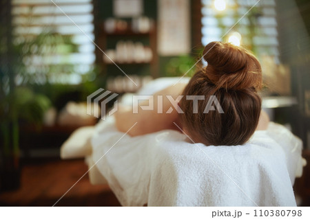 relaxed 40 years old woman in spa salon laying on massage table 110380798