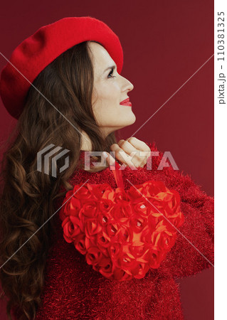 happy modern woman in red sweater and beret with red heart 110381325