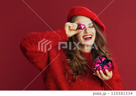 smiling stylish woman in red sweater and beret smiling stylish woman in red sweater and beret 110381334