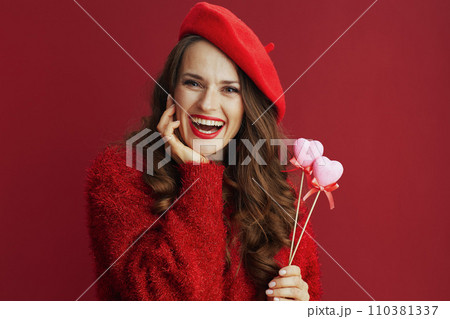 happy modern woman in red sweater and beret 110381337