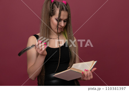 Woman writes in her notebook isolated on red background Woman writes in her notebook isolated on red background 110381397