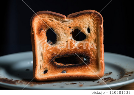 Burnt toast with an angry face expressing the emotion of sadness or sarcasm. 110381535