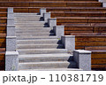wooden benches along the granite stairs going up to the street theater on a sunny summer day, nobody. 110381719