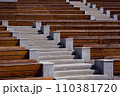 granite stairs between empty wooden benches at street theater on a sunny summer day, nobody. 110381720