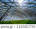 glass roof under the open sky with sun glare, indoor safety park with green hill lit by sunlight, nobody. 110381730