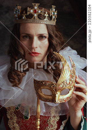 medieval queen in red dress with venetian mask medieval queen in red dress with venetian mask 110382104