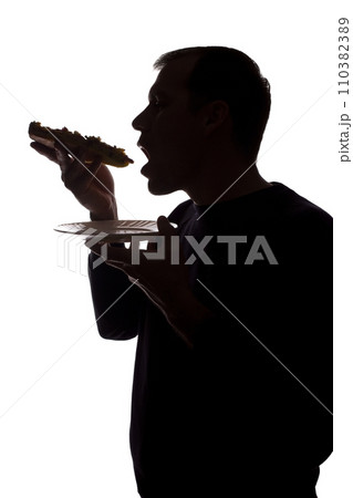 Portrait of a young man eat pizza, side view - silhouette 110382389