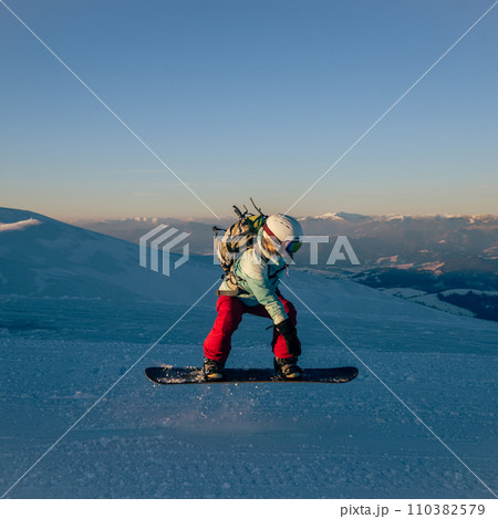 Young woman on the snowboard 110382579
