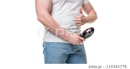 Man crop view giving thumb holding eggplant at crotch level imitating erect penis isolated on white 110382776