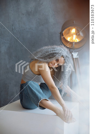 Female model with grey lush hair posing in studio 110383673