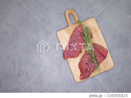 Fresh rib eye steak on wooden cutting board. Sliced beef steak Fresh rib eye steak on wooden cutting board. Sliced beef steak 110383823