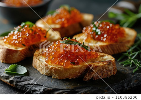 Sandwich with red caviar: a gourmet delicacy on a wooden table 110386200