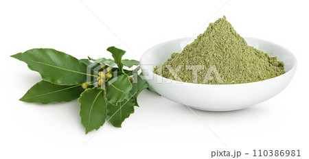 Fresh and ground Laurel leaves in ceramic bowl isolated on white background. Green bay leaf Fresh and ground Laurel leaves in ceramic bowl isolated on white background. Green bay leaf 110386981